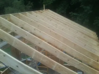 New roof rafters set over an addition before sheathing in Beech Creek